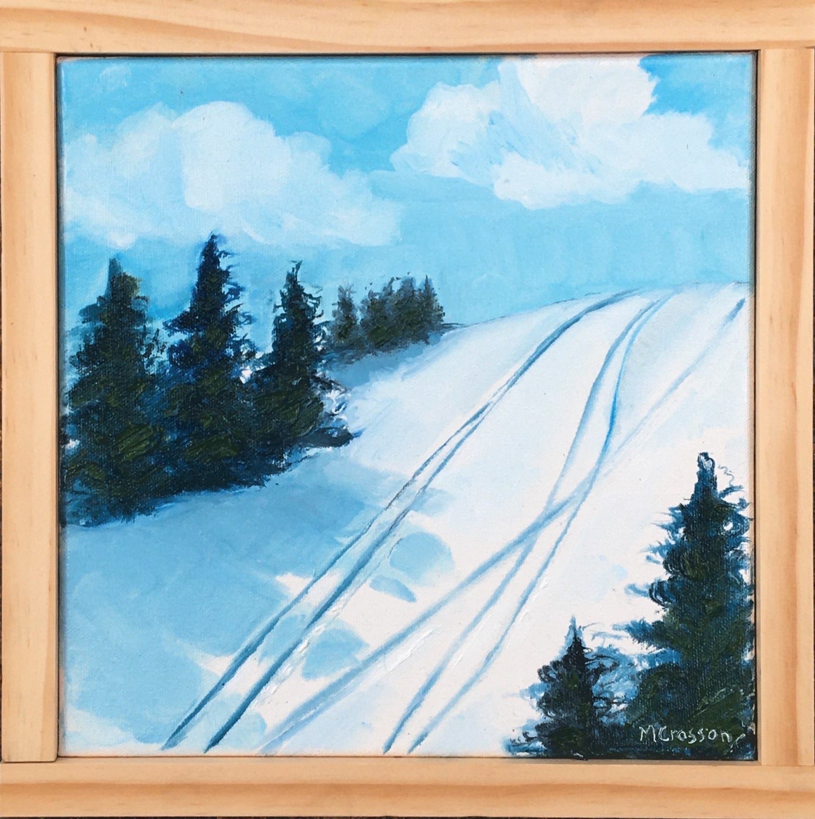 Framed painting of a ski slope surrounded by trees by Melissa Crosson